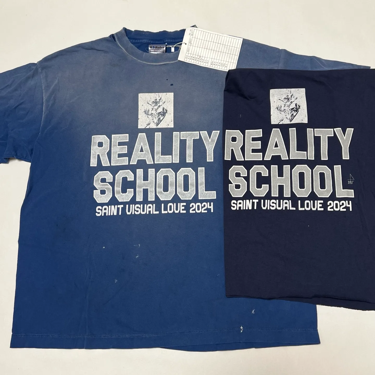 Printing proofing SAINT Mxxxxxx REALITY SCHOOL SS_TEE/NVY Slogan distressed short-sleeves Washed blue S-XL Garment dyeing Ma Liu fading Super complex shearing and destruction treatment Correct version Cylindrical fabric Customized original consistent main mark/wash mark Original consistent silver powder printing Distressed treatment